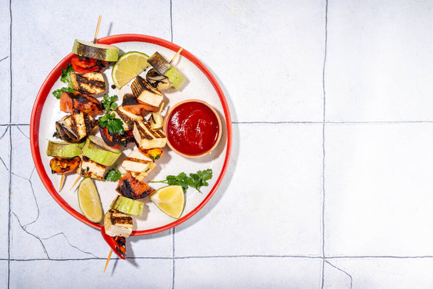 Summer vegan barbeque recipe. BBQ healthy balanced vegetarian food, grilled roasted tofu soy  cheese kebabs on skewers with vegetables, copy space - Photo, Image