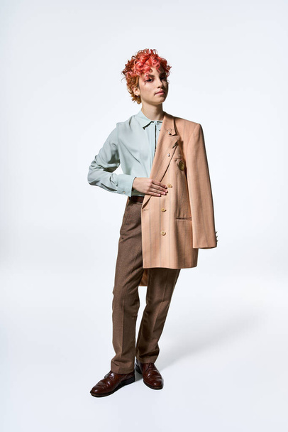 Extraordinary woman with red hair wearing a suit and jacket. - Photo, Image