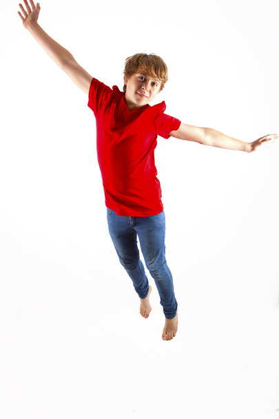Smart boy with red shirt jumping in the air - Φωτογραφία, εικόνα