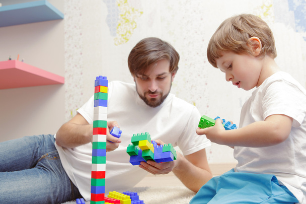 Father and son play with building kit - 写真・画像