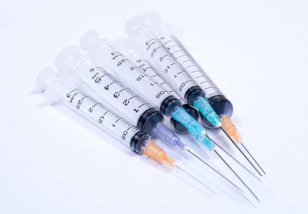 Syringe with droplet and medical on white background. - Photo, Image