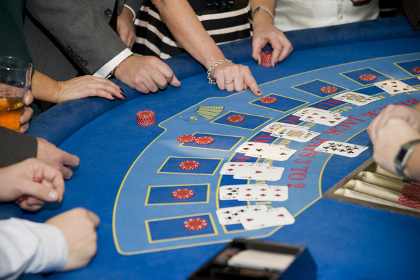 Image of men and women gambling playing blackjack cards - Фото, изображение