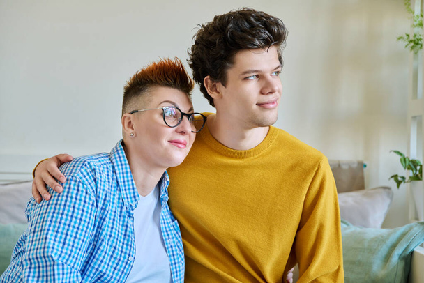Portrait of a happy middle-aged mother and son 19-20 years old hugging together. Mothers day, family, parenthood, tenderness, parent and son, two generations concept - Фото, зображення