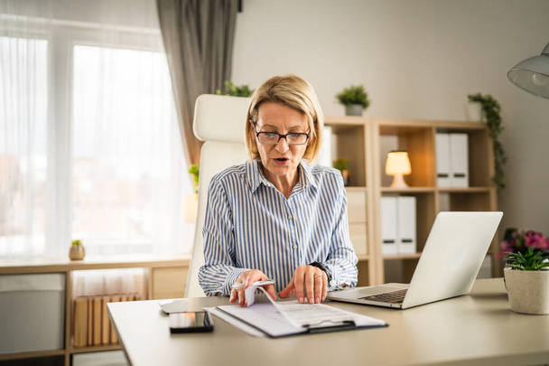 Mature woman businesswoman sign document contract at office at work - Photo, Image