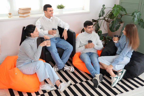 Young colleagues having coffee break in office - Photo, Image