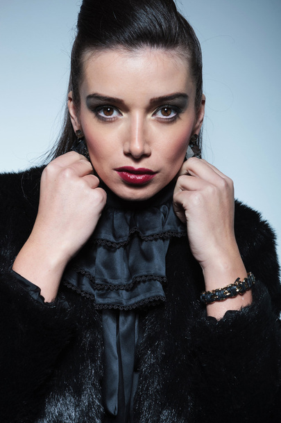  beautiful young fashion woman pulling her collar - Fotografie, Obrázek