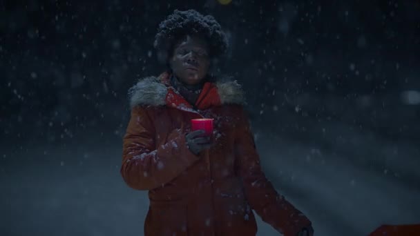 Black Female Person with Curly Hair Holding Candlelight in Snowy Winter Weather - Footage, Video