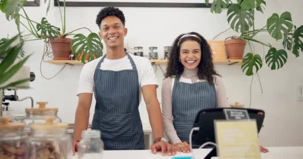 Barista, coffee shop and employees with services, shop and coworkers with smile and professional. Face, man and woman in a cafe and teamwork with cooperation and confidence with small business or joy. - Footage, Video