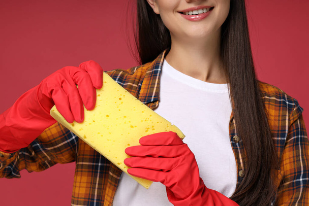 Housewife, in rubber gloves, on a bright background. - Photo, Image