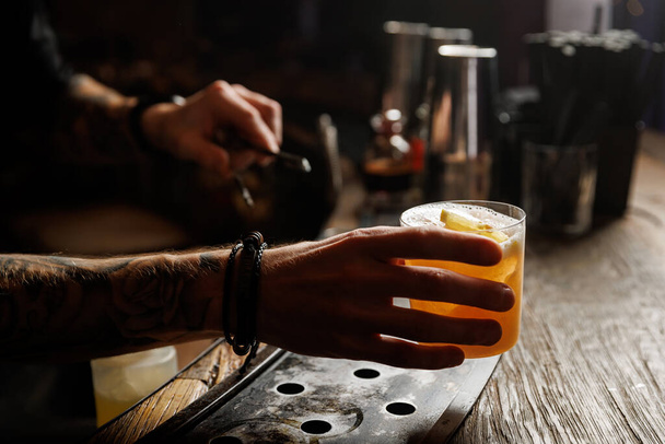 Whiskey sour cocktail on a wooden bar counter in a pub - Fotografie, Obrázek