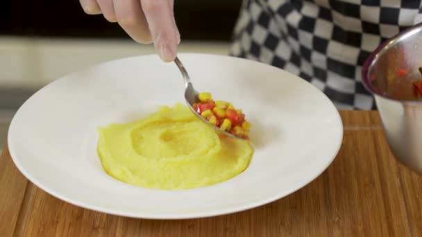 Chef kocht Hirsebrei mit Gemüsesalsa und Eigelb - Filmmaterial, Video