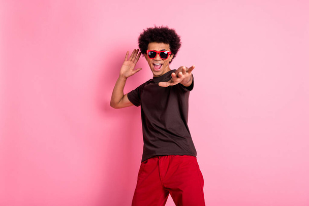 Photo of young macho boyfriend in sunglasses funky dancer active moves chilling bachelor discotheque isolated on pink color background. - Valokuva, kuva