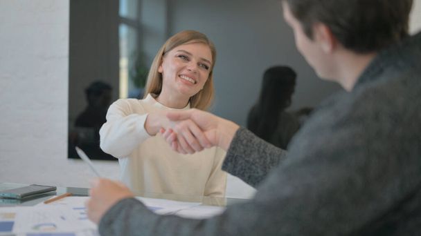 Confident Young Woman Shaking Hand with Partner - Photo, Image