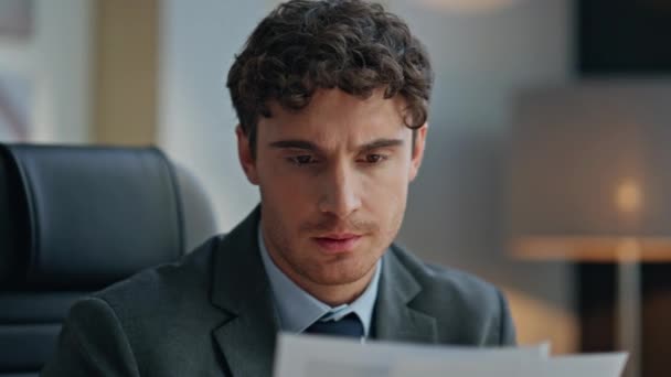 Experienced businessman reading documents at desk closeup. Pensive disappointed executive planning future partnership thinking problems in office. Middle aged unshaven man manager feeling worried - Footage, Video