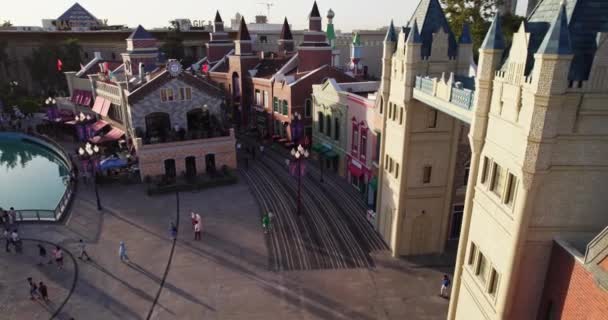 Drone flying on vacationing people in amusement park. Aerial View. - Footage, Video
