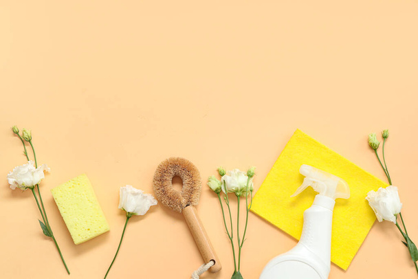 Bottle of cleaning product with tools and spring flowers on beige background - Photo, Image