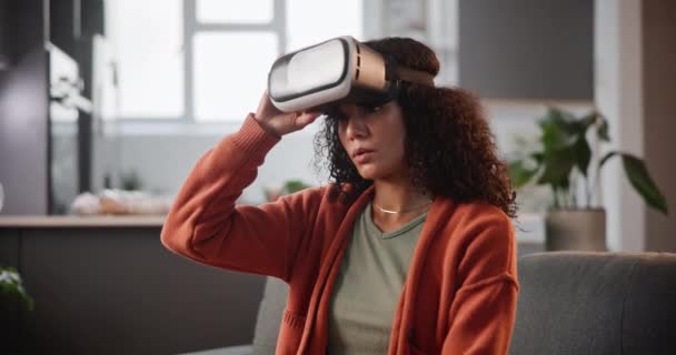 Woman, headache and VR with stress, nausea or motion sickness on living room sofa at home. Dizzy female person with sore head, confusion or pain from long hours on virtual reality headset at house. - Footage, Video