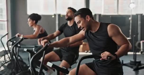 Friends, workout and gym together with high five for fitness, training and exercise to build muscle on arms or legs. People, crosstrainer or cycling bike for cardiovascular strength and determination. - Footage, Video