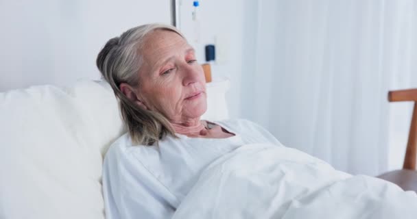 Elderly, woman and resting in hospital bed, checkup or appointment for sickness or healthcare with patient. Female person, surgery recovery or treatment in clinic, breathing or procedure or operation. - Footage, Video
