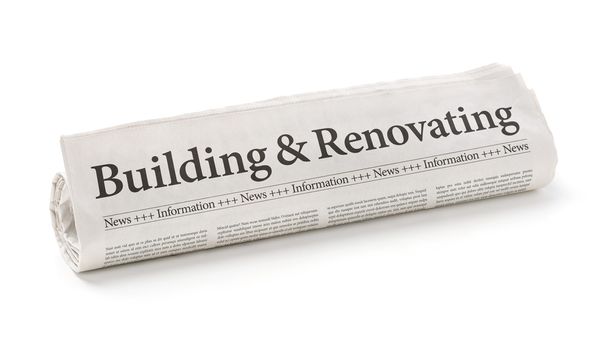 Rolled newspaper with the headline Building and Renovating - Photo, Image