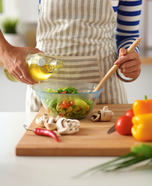 Young woman mixing fresh salad - Photo, image