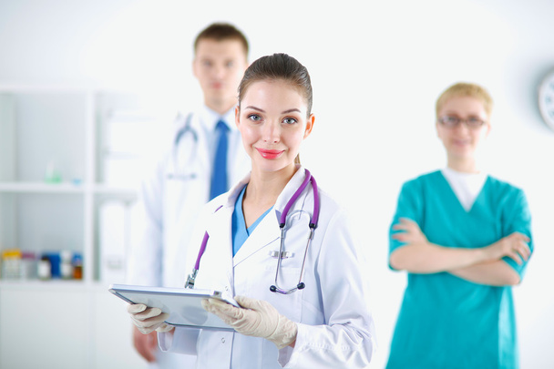 Woman doctor standing with folder at hospital - Foto, Bild