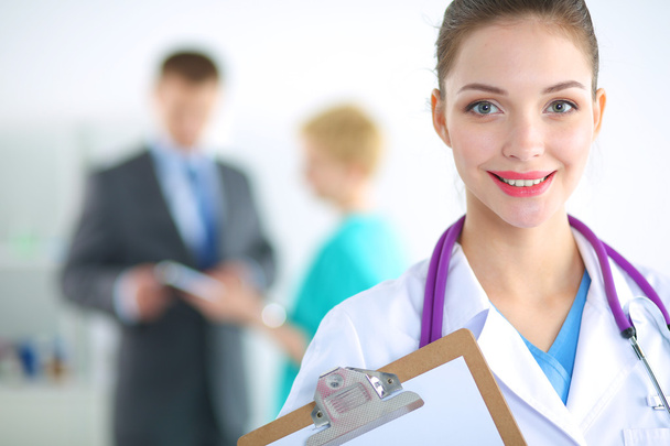 Woman doctor standing with folder at hospital - Foto, Imagen