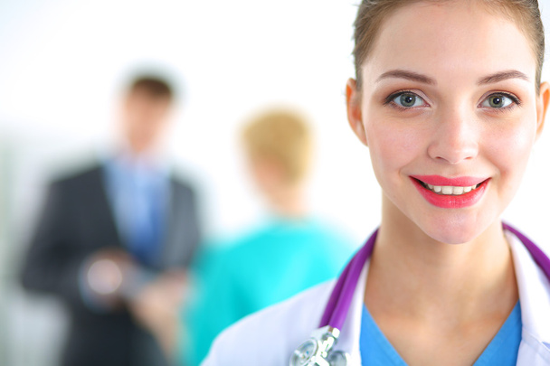 Woman doctor standing with stethoscope at hospital - Zdjęcie, obraz