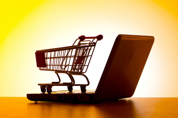 Silhoette of shopping cart and laptop - Photo, Image