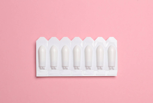 Ampollas de supositorios vaginales sobre fondo rosa - Foto, Imagen