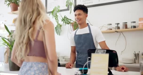 Service, barista or customer order at cafe for food or help at table in a coffee shop job with menu. Listening, waiter or employee in small business restaurant talking a woman, lady or girl client. - Footage, Video