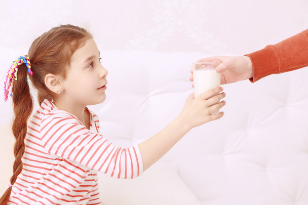 Little girl getting glass of milk - Photo, image