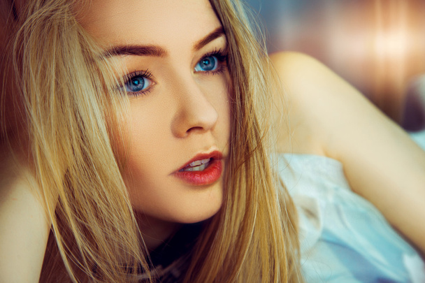 Indoors portrait of beauty young woman with blue eyes - Photo, Image