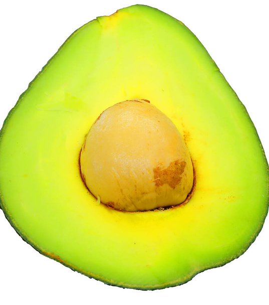 ripe green avocado with a large seed in the middle - Photo, Image