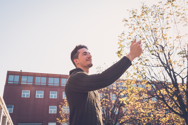 Young handsome man taking a selfie - Foto, imagen