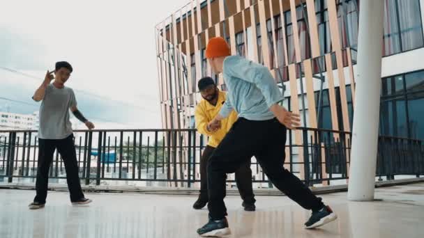 Ryhmä hipsteriä siirtymässä hip-hop-musiikkiin käytävällä. Taitava break tanssija suorittaa b-poika tanssi kun ympäröi monikulttuurinen ystävä tai tanssiryhmä. Ulkona urheilu 2024 hip hop. - Materiaali, video