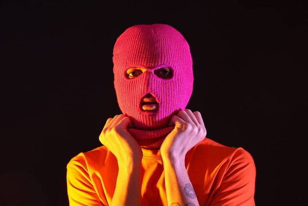Handsome young man in balaclava on black background - Photo, Image