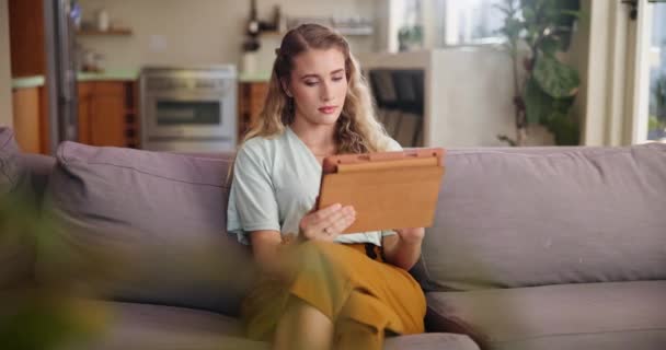 Tablet, search or woman on sofa thinking, planning or curious about home, loan or mortgage application process. Why, questions or female person in living room with digital app for credit score check. - Footage, Video