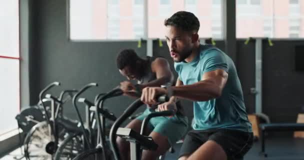 Bike, gym and people with cardio, wellness and challenge with endurance and progress with cycling. Health, group and equipment with energy and fitness with increase heart rate or elliptical machine. - Footage, Video