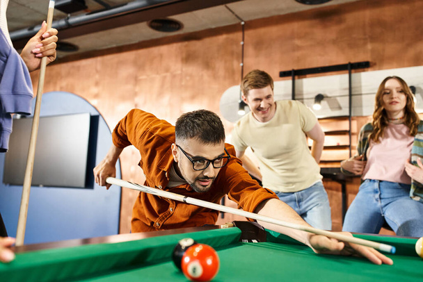 Successful startup team enjoying a game of pool in a stylish office, bonding and strategizing during a break. - Photo, Image