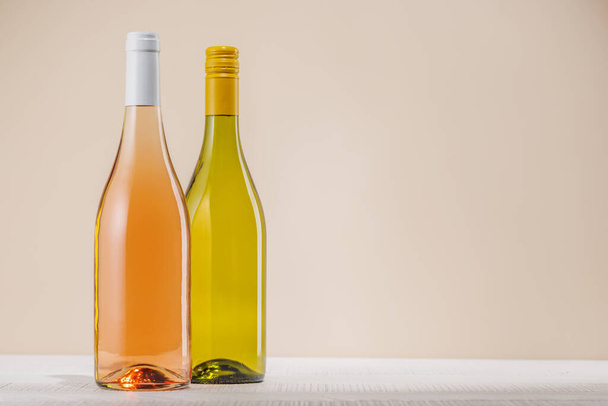 Rose i białe butelki wina na stole z miejsca do kopiowania - Zdjęcie, obraz