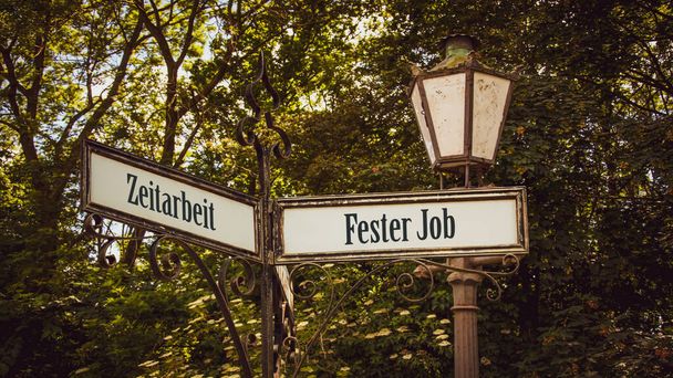 Obraz z drogowskazem wskazującym w dwóch różnych kierunkach po niemiecku. Jeden kierunek wskazuje na stałą pracę, drugi na pracę tymczasową.. - Zdjęcie, obraz