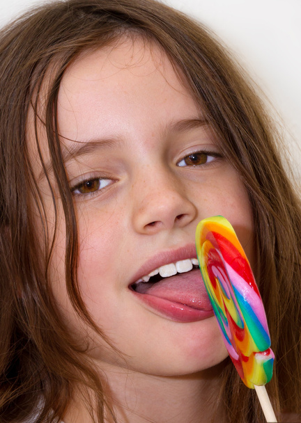 Little girl with colorful lollipop - Фото, зображення
