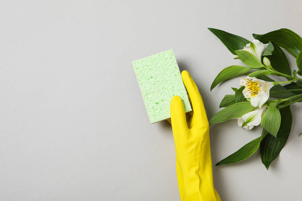 Washcloth and rubber glove with fresh flowers - Photo, Image