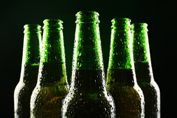 glass bottles of beer on dark background - 写真・画像