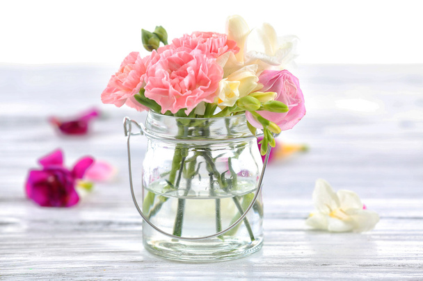 Beautiful spring flowers in glass bottle - Foto, imagen