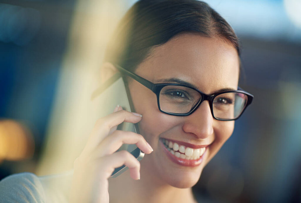 Business woman, smile and mobile conversation in office for communication, sales and corporate deals. Person, happy and talking on cellphone device for agreement, negotiation and job opportunity. - Photo, Image