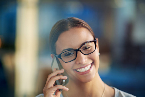 Business woman, smile and cellphone conversation in office for communication, sales and corporate deals. Person, happy and talking on mobile device for agreement, negotiation and job opportunity. - Photo, Image