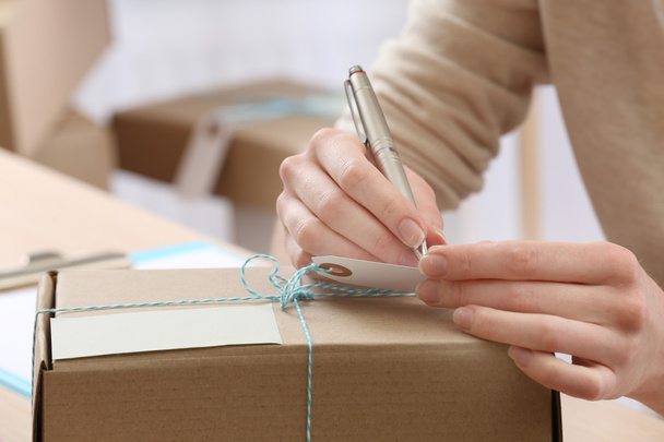 Woman signs parcel in post office - Фото, зображення