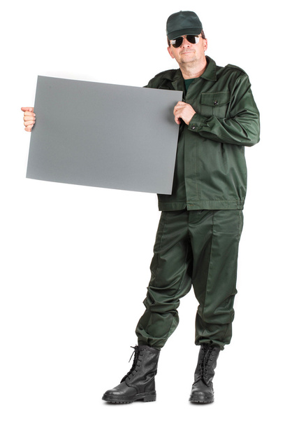 Man in workwear stands with paper. - Photo, image